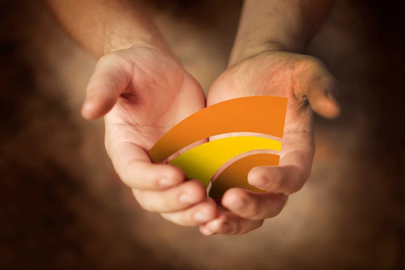 Hands holding the Sunstate logo